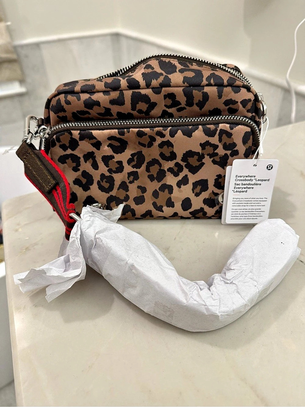 Lululemon crossbody camera bag, leopard print with striking red stripe strap Mea
